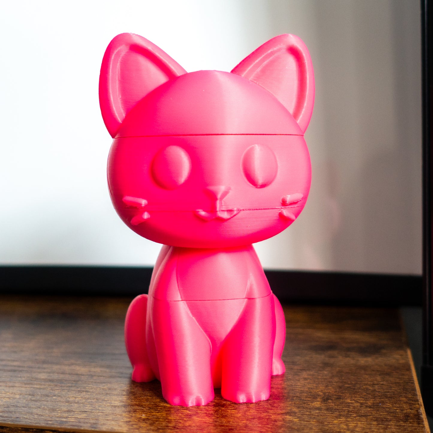 Close-up of Whisk the toy cat featuring engraved detail and a grippable shape