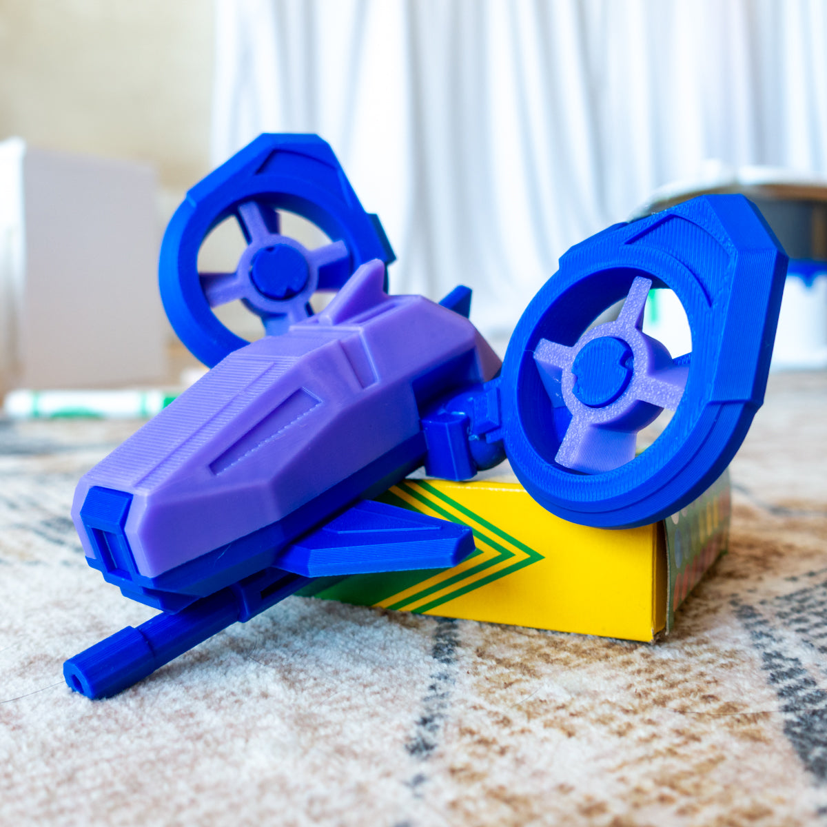 DosFly the Dual Drone toy posed on carpet with adjustable prop arms and mix-and-match color system