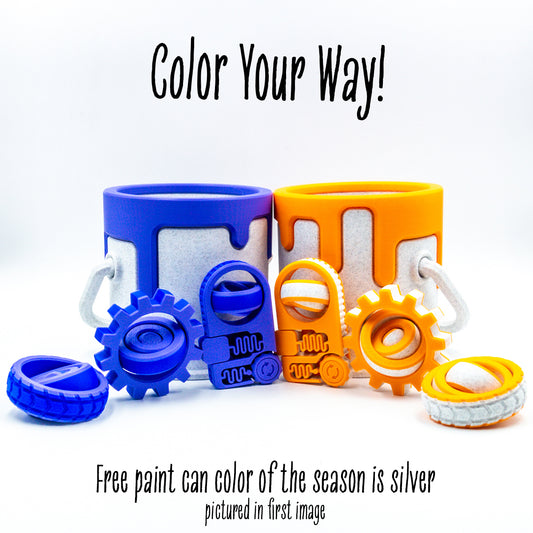 Studio photo of 2 Engineer Packs each with 3 fidget toys and paint can showing articulated design and tactile details.