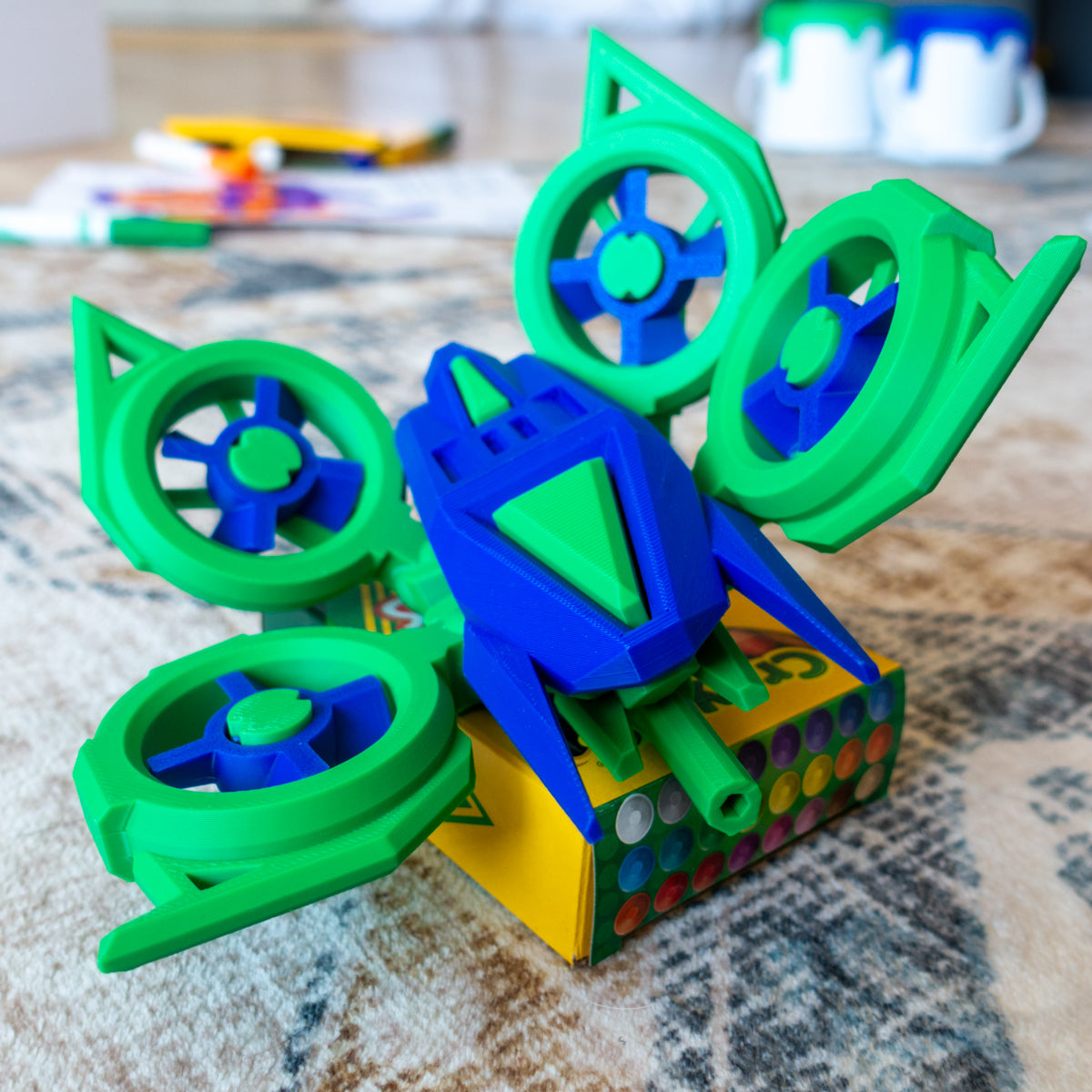 Huvver the Quad Copter toy posed on a carpet with rotating arms and modular build for aerial adventures
