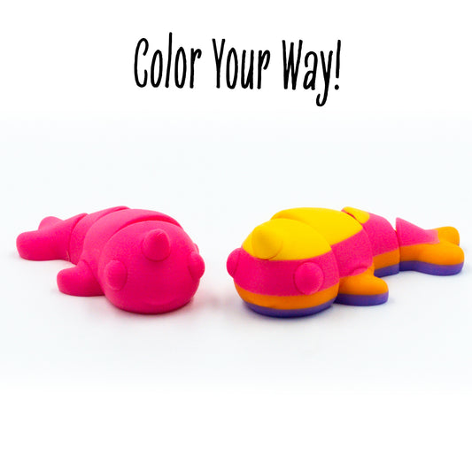 Spiral the narwhal toy in a group shot to show customization options