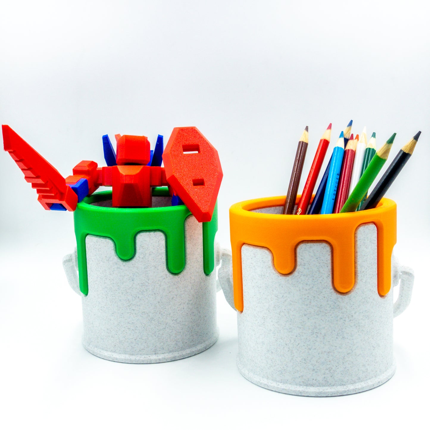 Two custom paint cans side by side, one filled with a toy and the other with pencils.