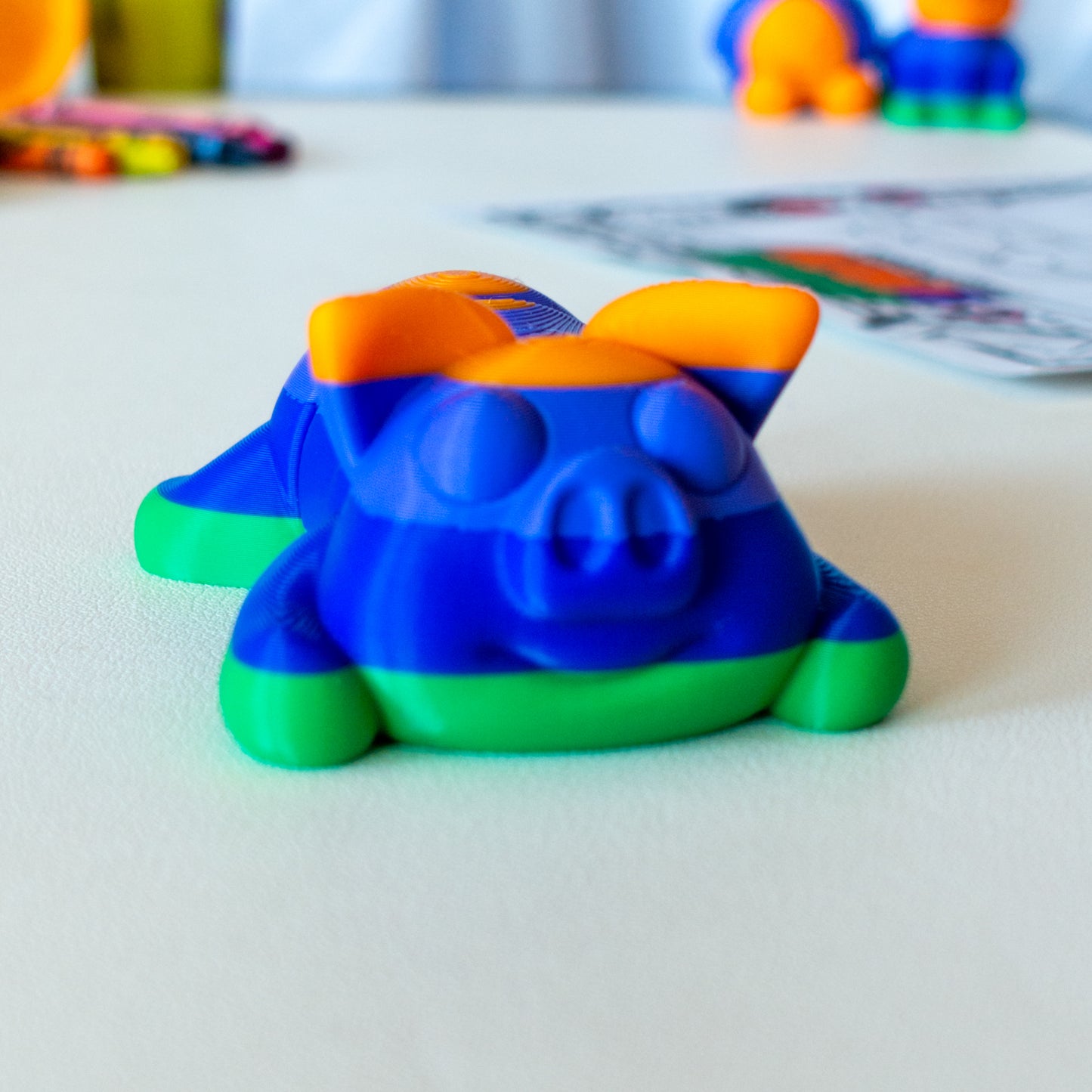 Snout Pig custom articulated animal toy posed on a coffee table, designed for tactile play and fidget-friendly movement