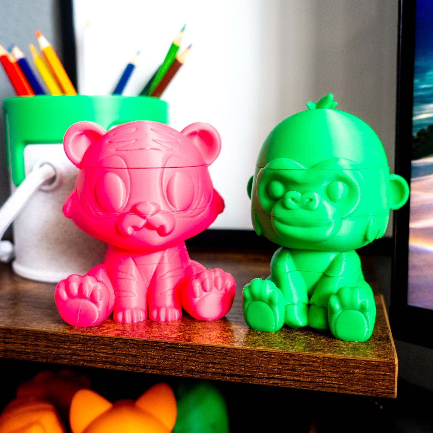 Roar the tiger and Rumble the gorilla paired beside a paint can, illustrating desk-friendly size and collectible appeal