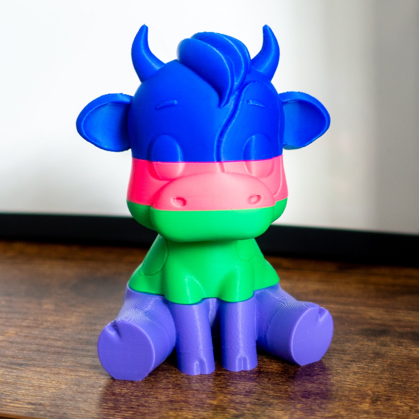 Mooch the cow shown fully stacked in four satisfying slices, ideal for tactile desk play