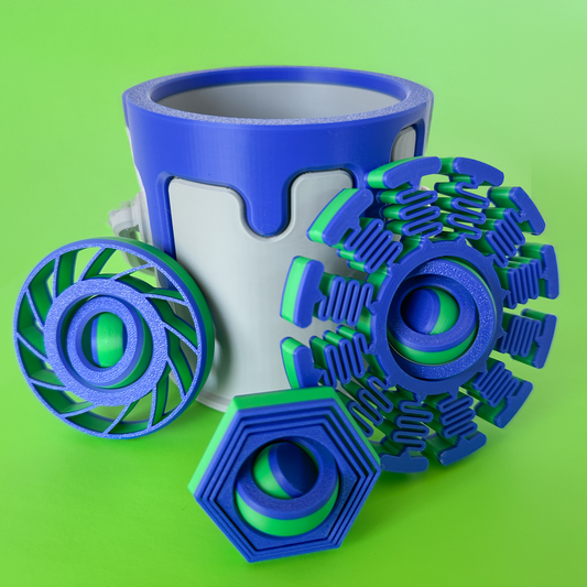Three fidget toys in blue and green against a paint can container with a blue drip on a green background.