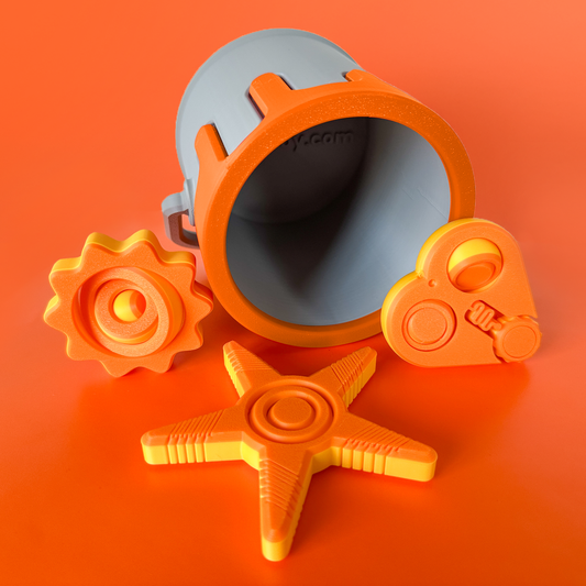 An orange and yellow set of three fidget toys with a paint can container with orange drip on an orange background