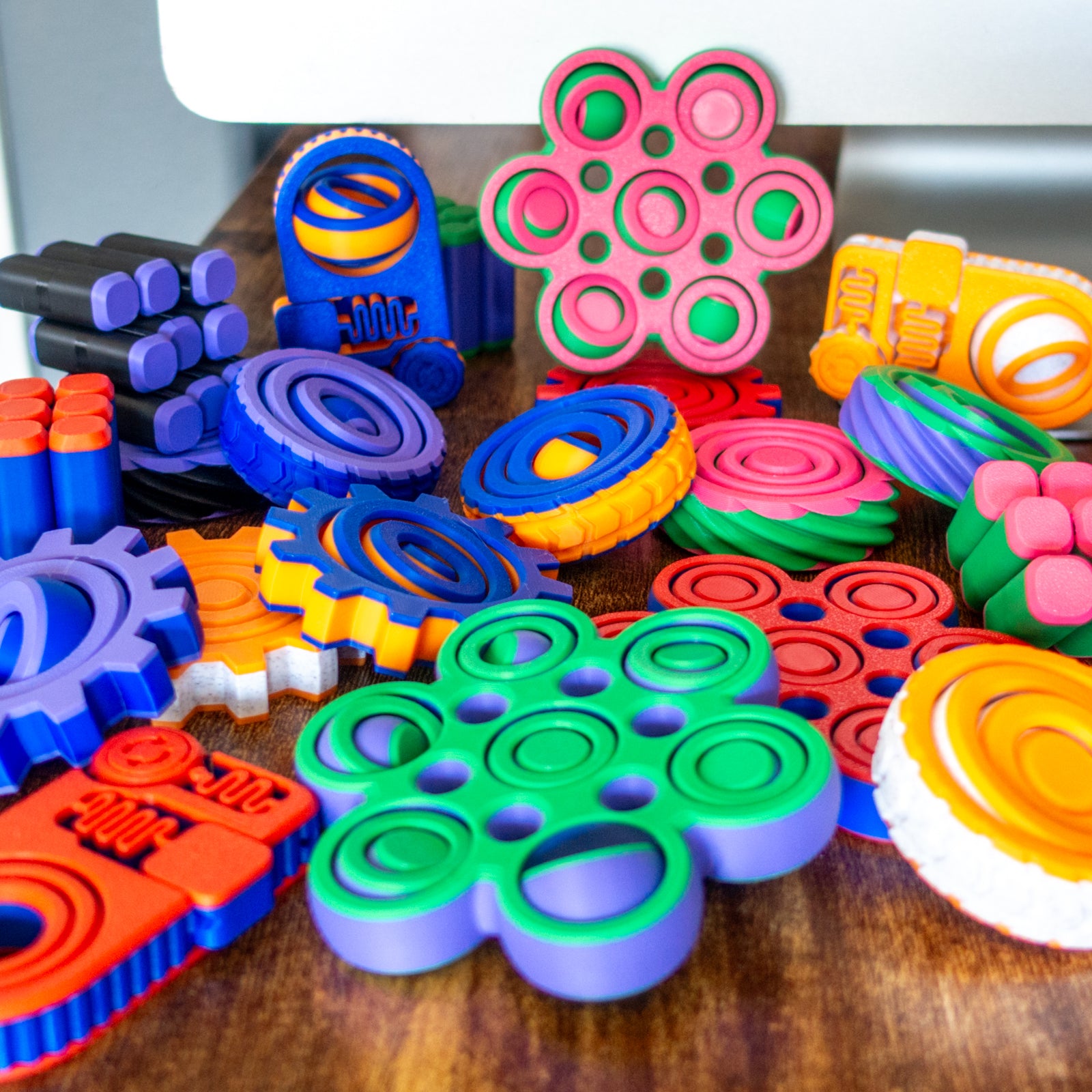 All of our fidgets in a fun looking pile inviting the user to touch and experience the tactile satisfaction of each.