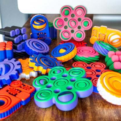 All of our fidgets in a fun looking pile inviting the user to touch and experience the tactile satisfaction of each.