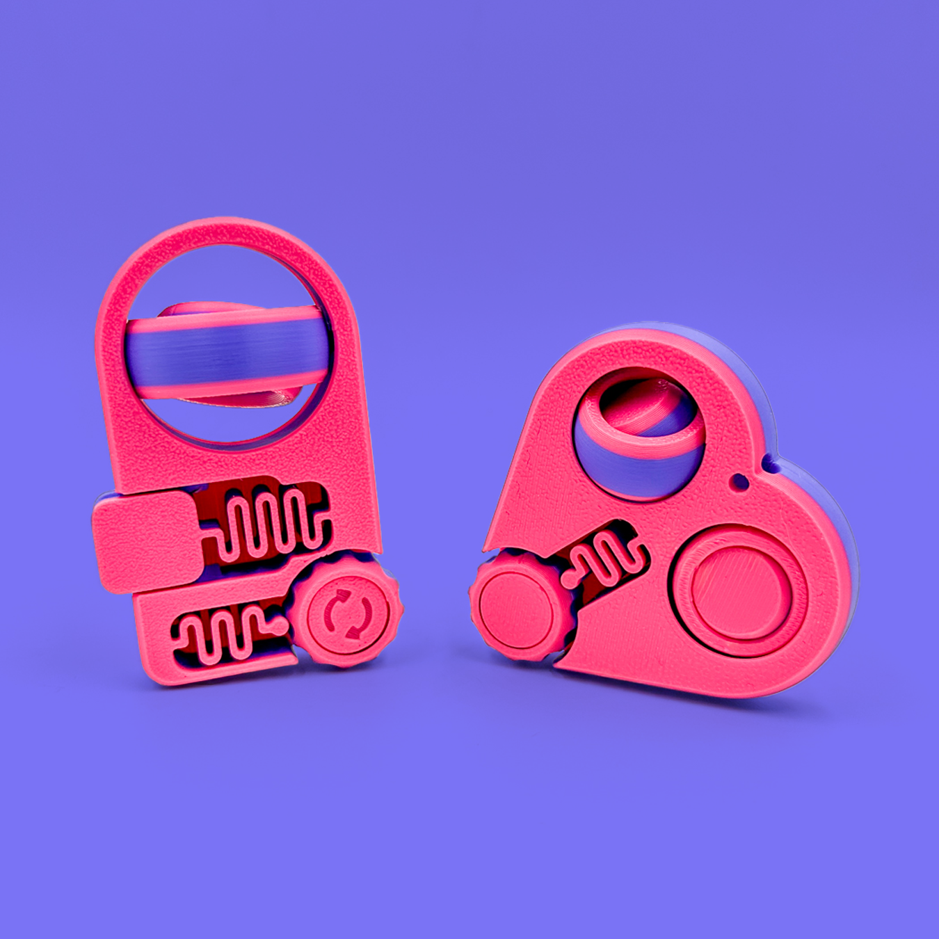 A pink and purple set of two fidget clickers on a purple backdrop.