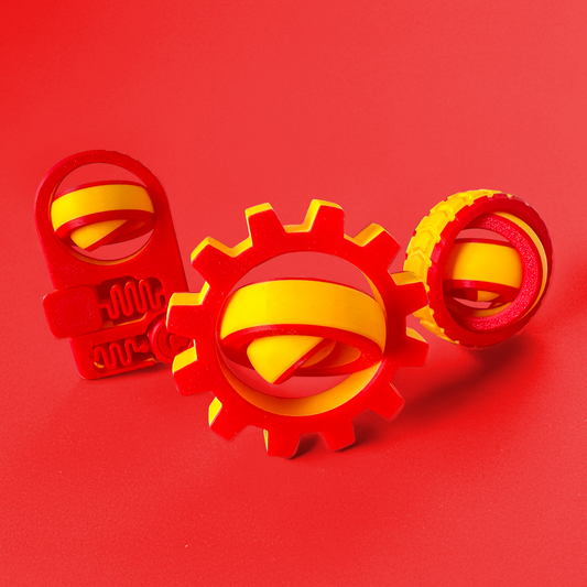 Three red and yellow fidget toys on a red background.