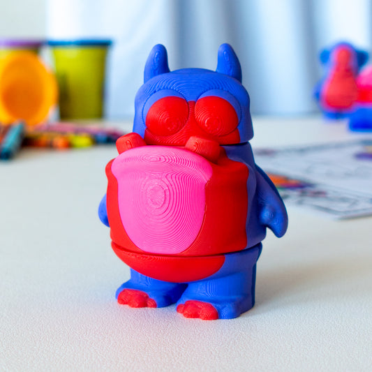 Gloop Toothy Alien custom articulated animal toy posed on a coffee table, designed for tactile play and fidget-friendly movement