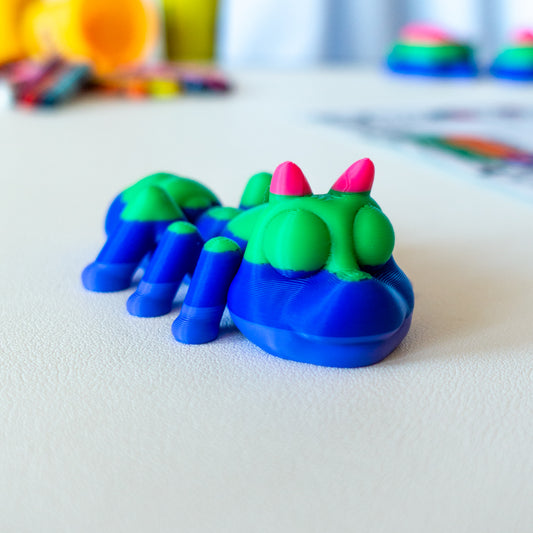 Lift Ant custom articulated animal toy posed on a coffee table, designed for tactile play and fidget-friendly movement