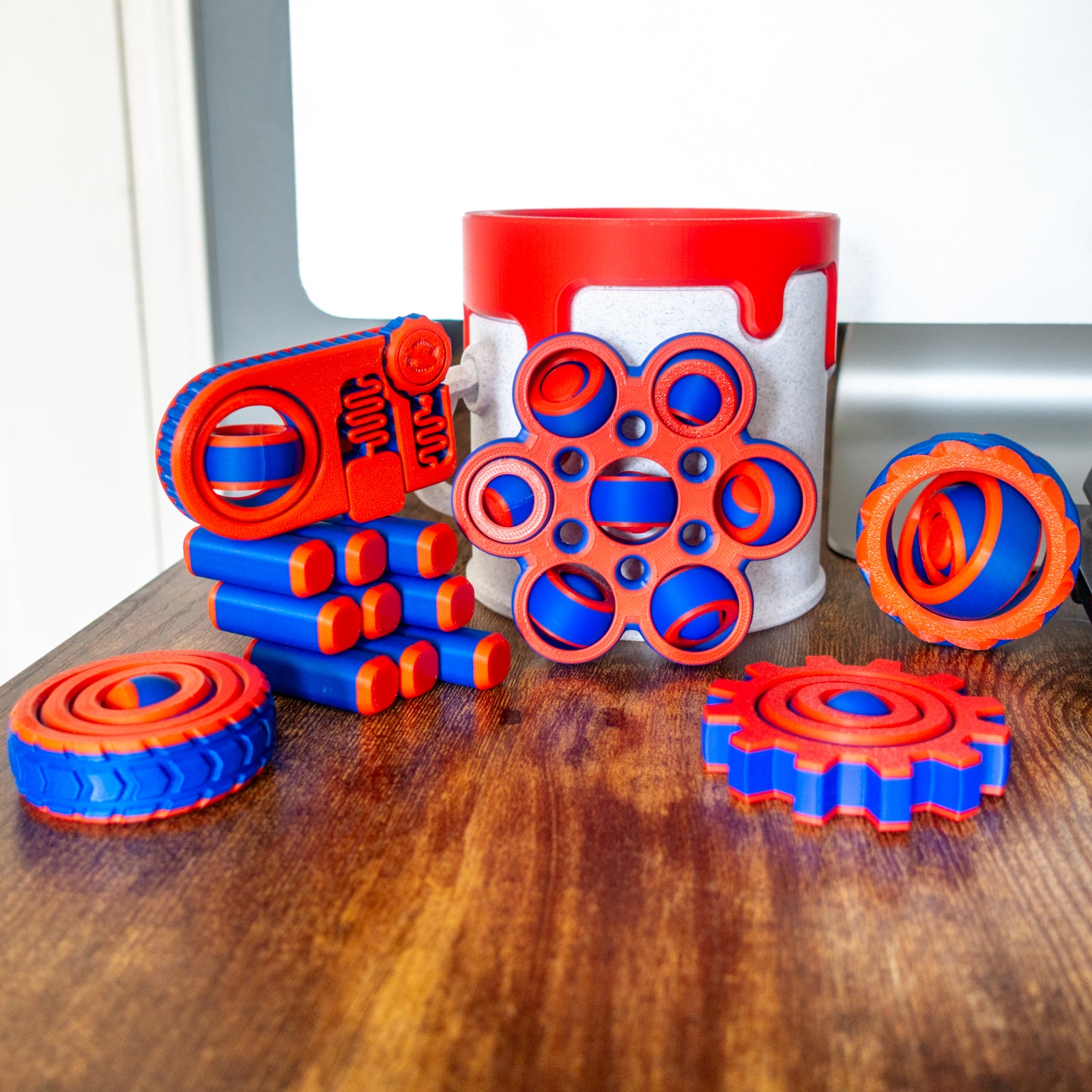 Mega Pack with all six fidget toys and a paint can in a dynamic lifestyle setting with articulated design and tactile details.