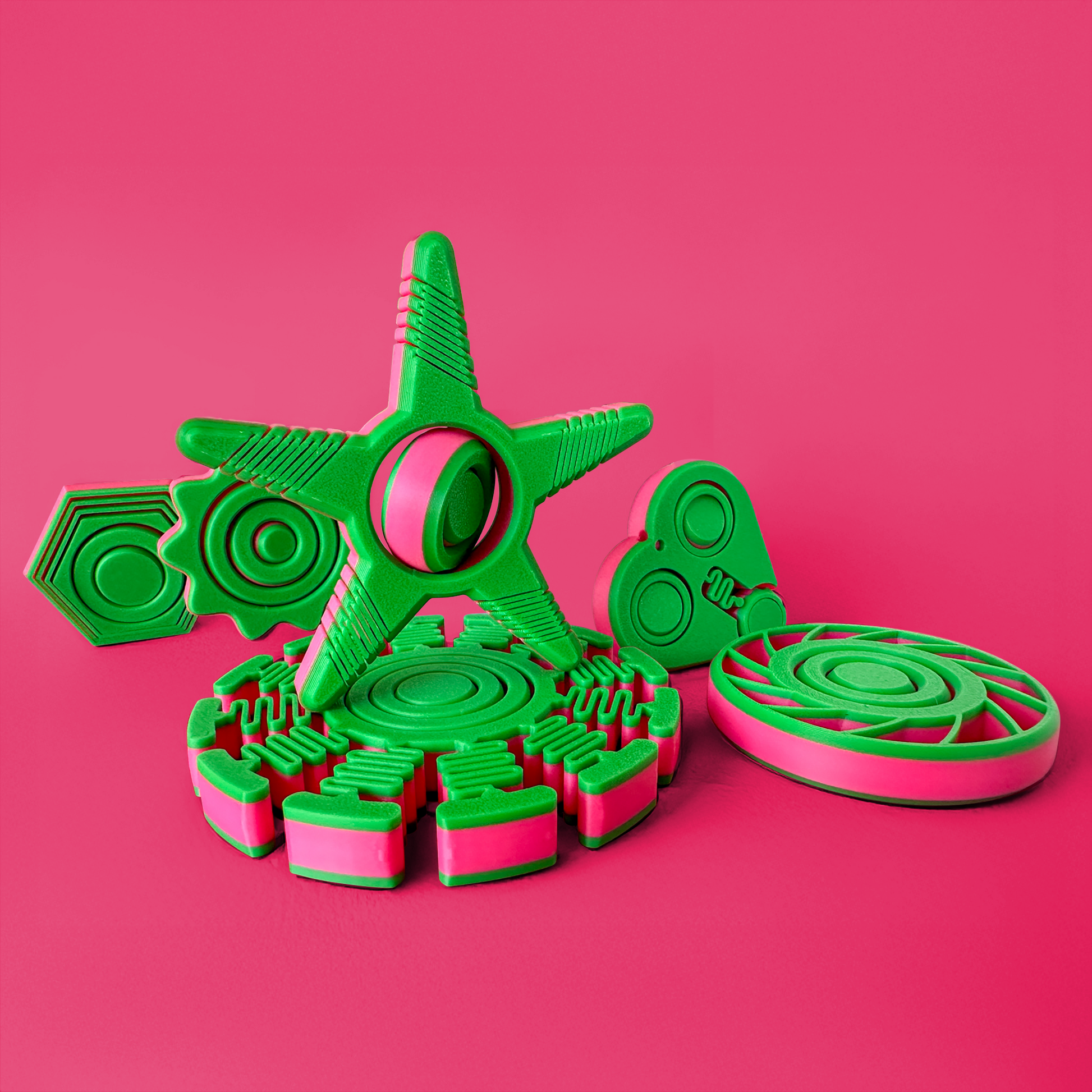 6 Green and pink plastic fidget toys with geometric shapes on a pink background