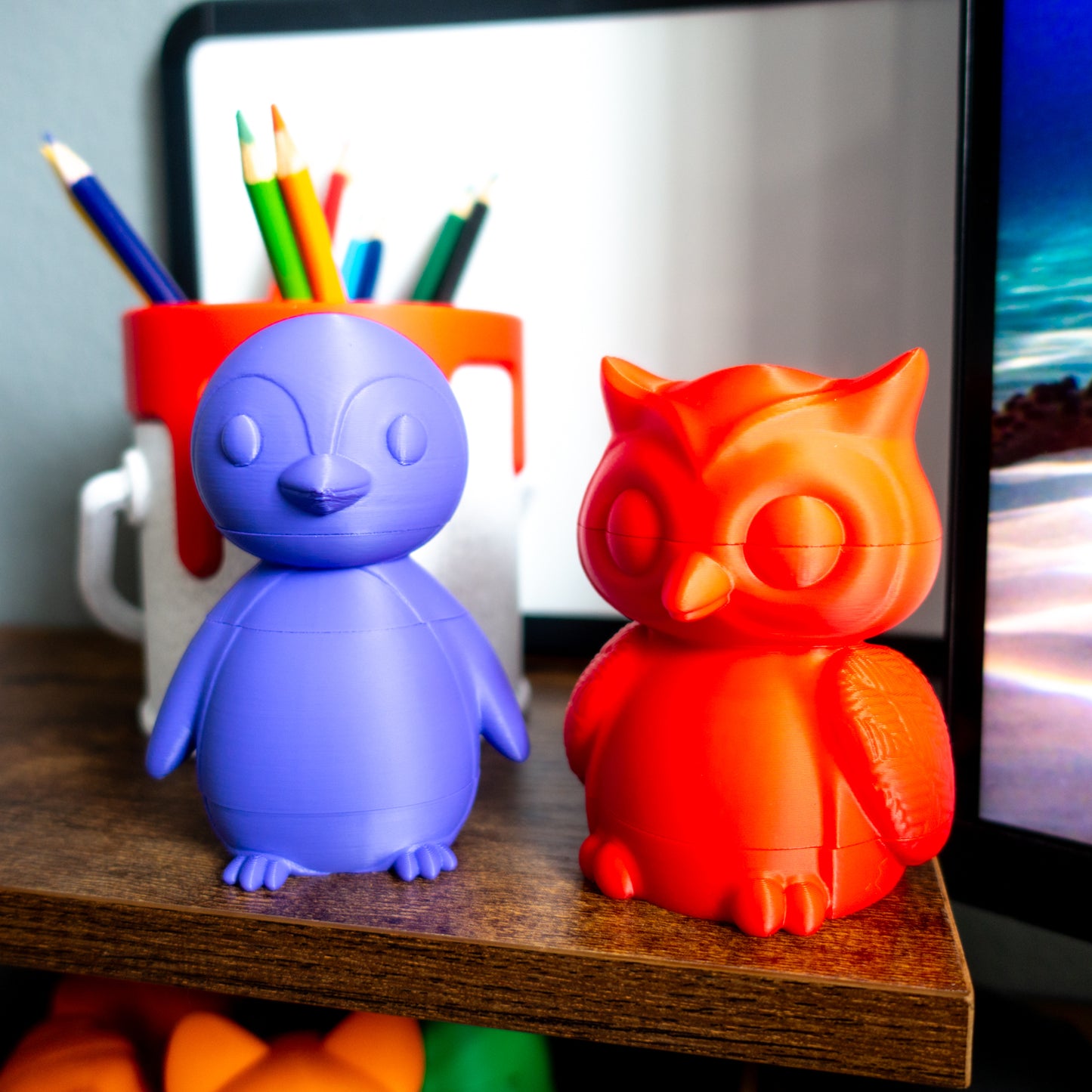 Close-up of Hoot the owl and Waddle the penguin toys featuring sculpted facial detail and tactile features