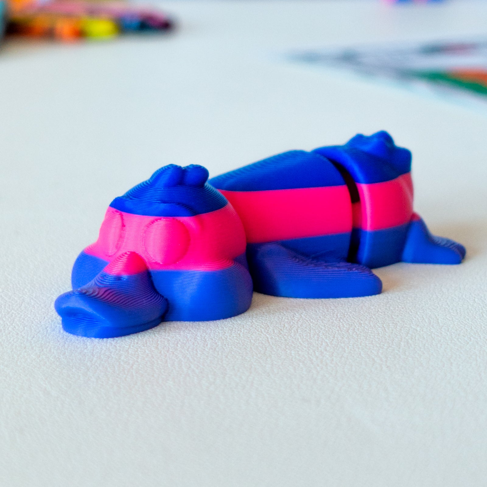 Paddle Duck custom articulated animal toy posed on a coffee table, designed for tactile play and fidget-friendly movement