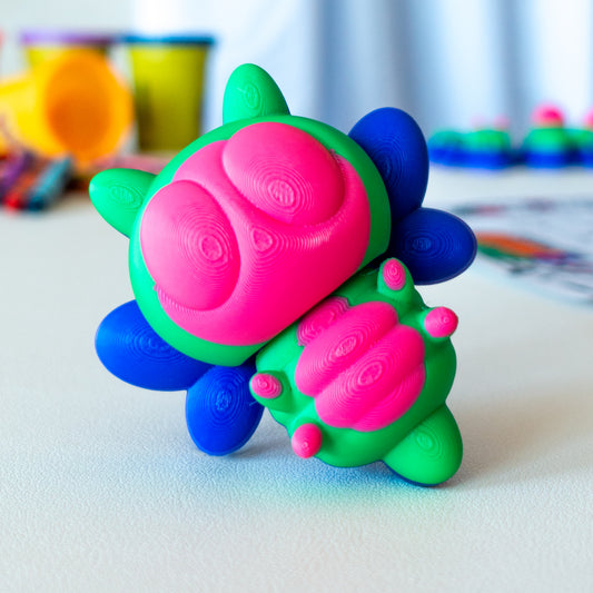 Queenbee Bumblebee custom articulated animal toy posed on a coffee table, designed for tactile play and fidget-friendly movement