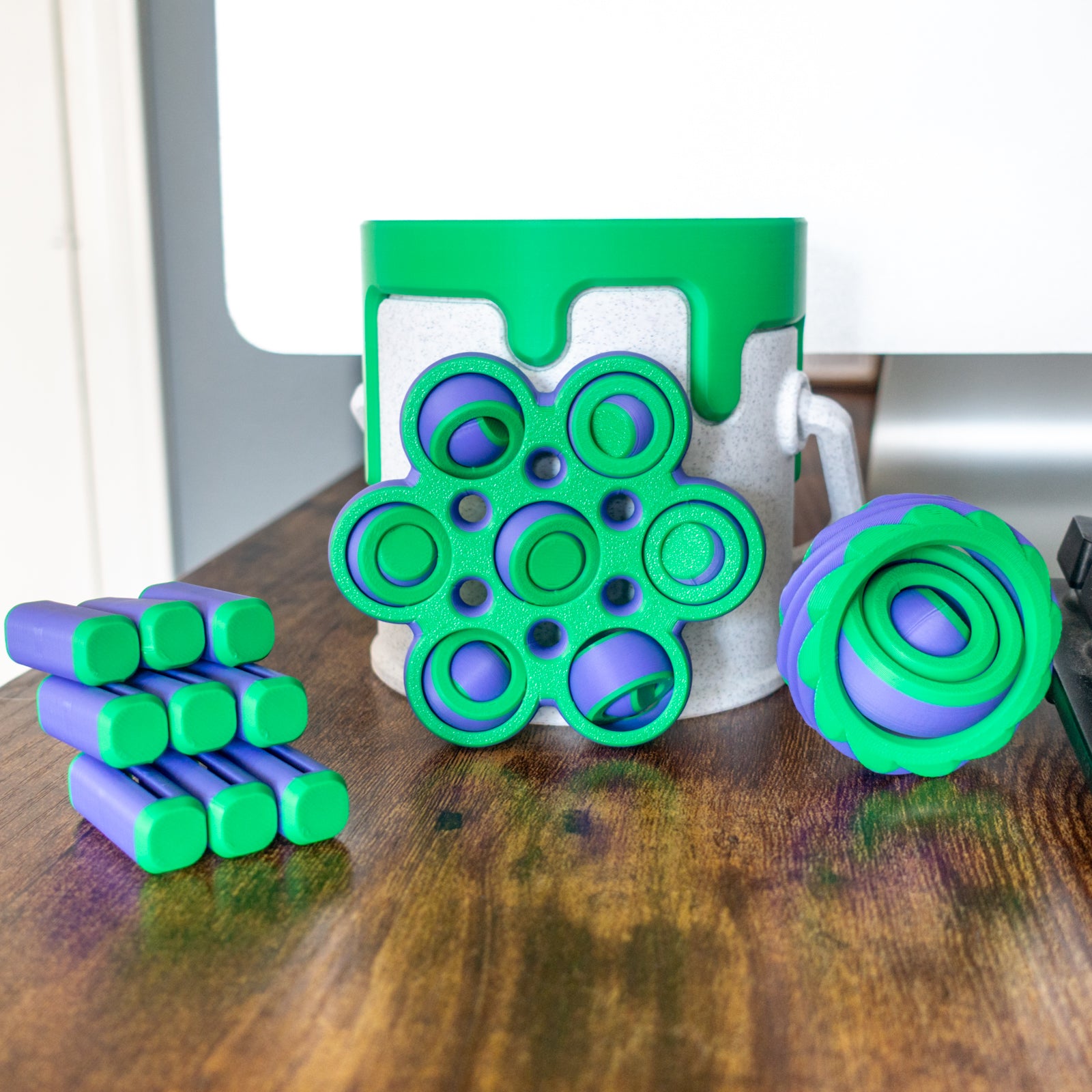 Scifi Pack with 3 fidget toys and a paint can in real-world setting featuring articulated design and tactile details.
