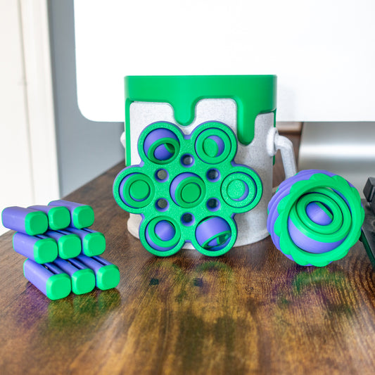 Scifi Pack with 3 fidget toys and a paint can in real-world setting featuring articulated design and tactile details.