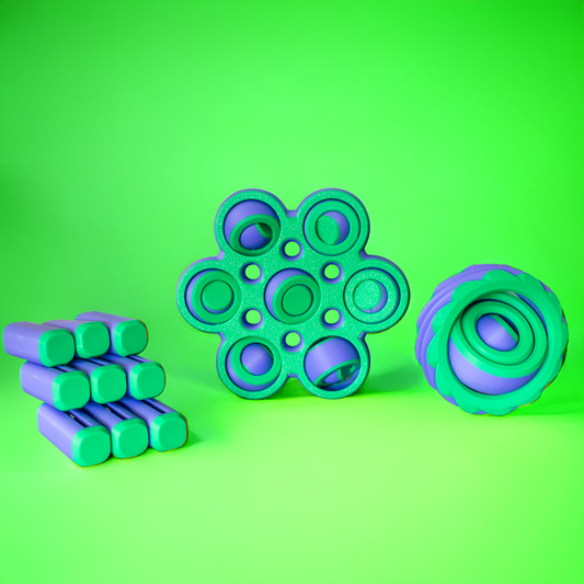 Three green and purple fidget toys on a green background.