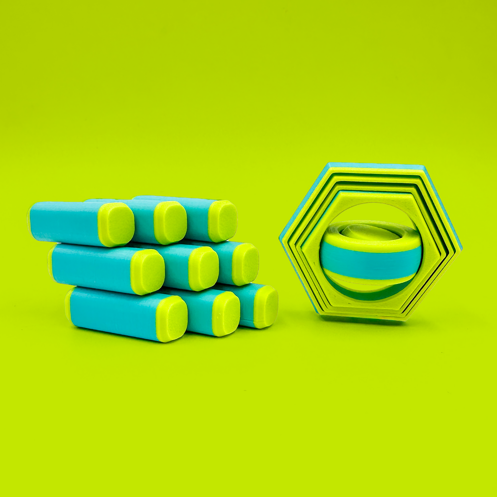 PixelCube and CoreShift fidget toys in neon green and aqua blue on a neon green backdrop.