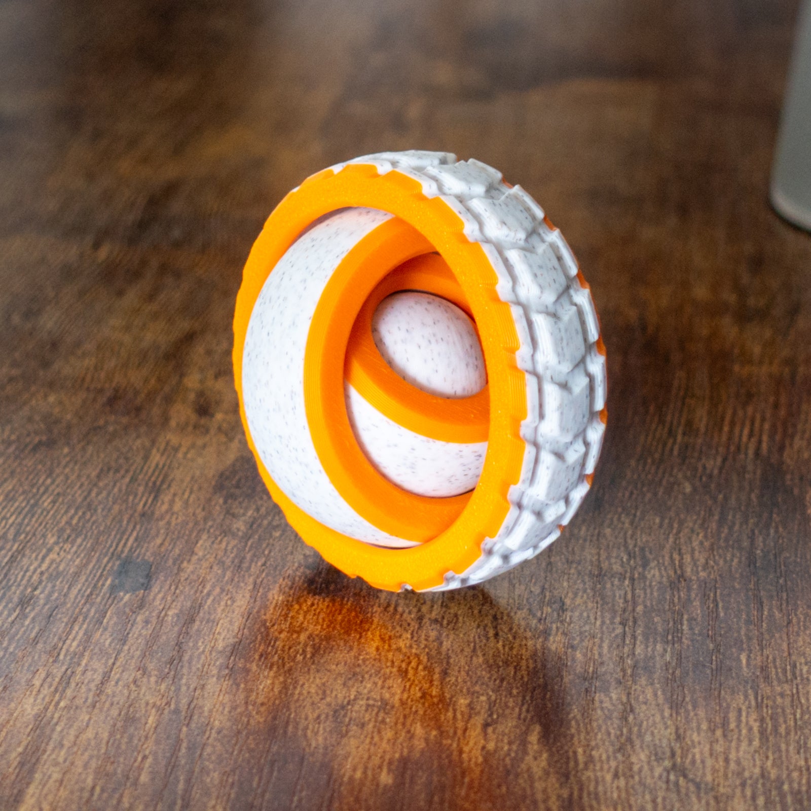 Tire Spin fidget shown in real-world play with articulated design and tactile details.