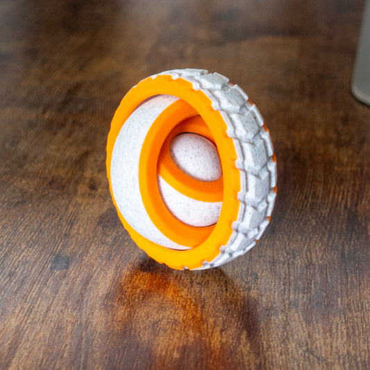Tire Spin fidget shown in real-world play with articulated design and tactile details.