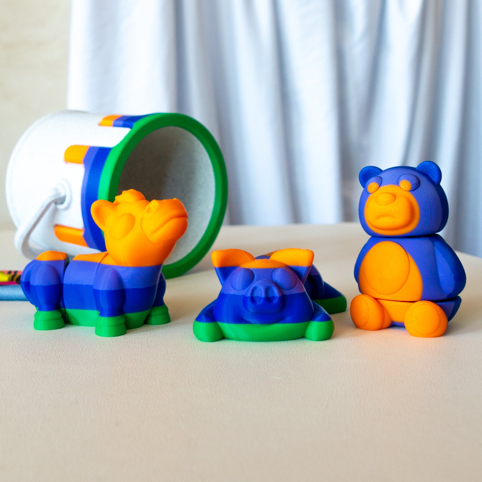 Main view of the articulated animal toy set featuring a bear, pig and horse articulated textured toys.