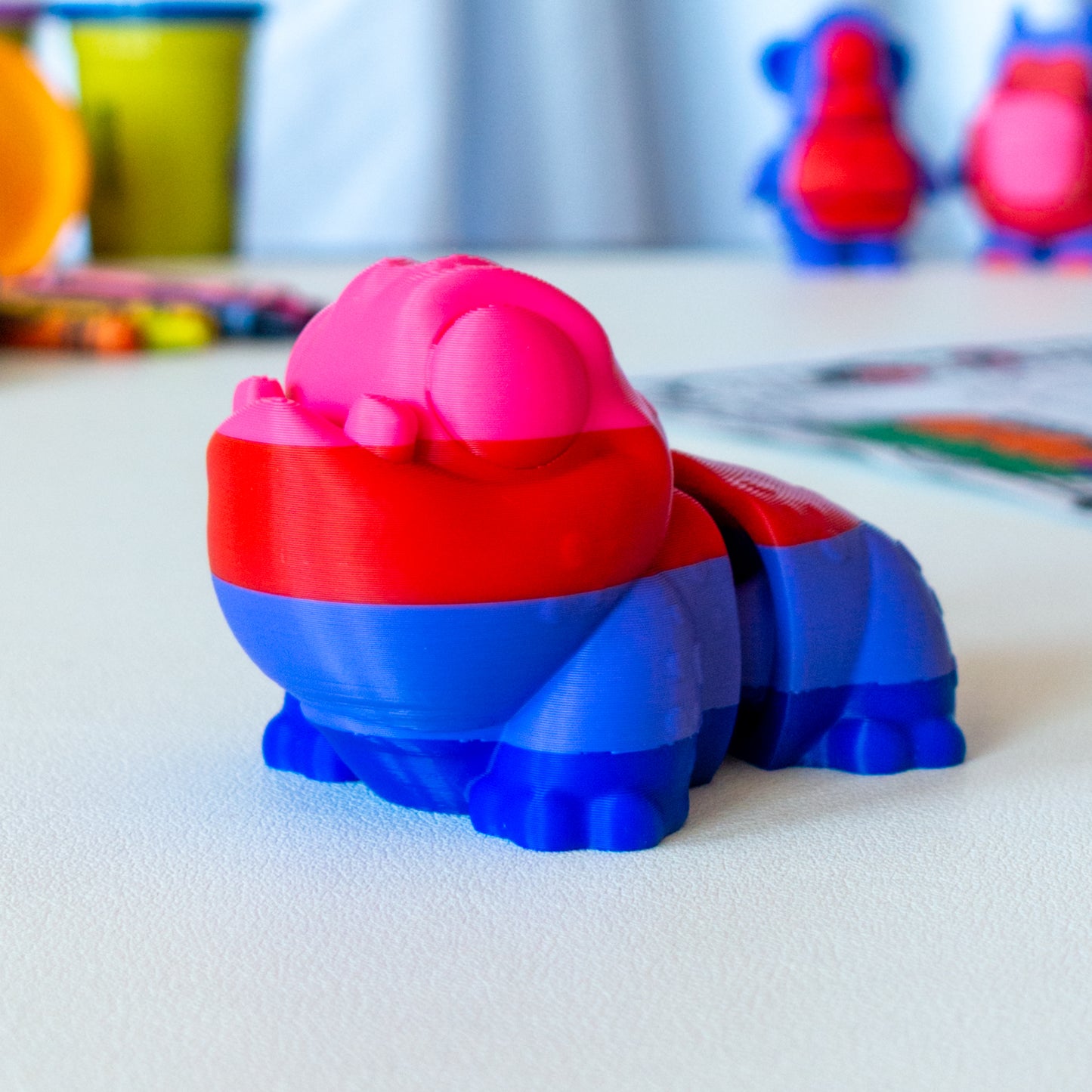 Zorb Alien Pet custom articulated animal toy posed on a coffee table, designed for tactile play and fidget-friendly movement